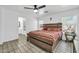 Cozy main bedroom with a ceiling fan, natural light, and neutral wall colors at 12709 N El Frio St, El Mirage, AZ 85335