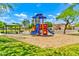 Community playground featuring modern play structure, picnic pavilion, and mature landscaping under a bright sky at 12709 N El Frio St, El Mirage, AZ 85335