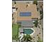 An aerial view of the property showcasing a pool, putting green, patio, and solar panels at 12753 W Vista Paseo Dr, Litchfield Park, AZ 85340