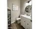 Bathroom featuring modern vanity, marble countertop, and fixtures, next to a toilet and shelving for storage at 12753 W Vista Paseo Dr, Litchfield Park, AZ 85340
