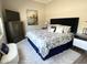 Comfortable bedroom featuring a plush bed with navy accents, complemented by stylish furnishings and a serene ambiance at 12753 W Vista Paseo Dr, Litchfield Park, AZ 85340