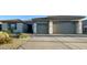 Contemporary home with desert landscaping and a wide driveway leading to an attached two-car garage at 12753 W Vista Paseo Dr, Litchfield Park, AZ 85340