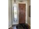 Attractive front entry featuring a solid wood door, sidelight window, and stylish decor at 12753 W Vista Paseo Dr, Litchfield Park, AZ 85340