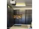 A well-organized garage featuring ample dark wood cabinets and a pegboard wall for tools at 12753 W Vista Paseo Dr, Litchfield Park, AZ 85340