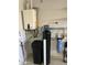 Efficient water heater and filtration system neatly installed in garage at 12753 W Vista Paseo Dr, Litchfield Park, AZ 85340