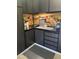 A well-organized garage featuring ample dark wood cabinets and a pegboard wall for tools at 12753 W Vista Paseo Dr, Litchfield Park, AZ 85340