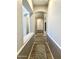 Hallway with wood-look flooring, earth-toned walls, arched doorways, and an area rug at 12753 W Vista Paseo Dr, Litchfield Park, AZ 85340