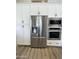 Kitchen with stainless steel appliances and white cabinets, including a built in microwave and oven at 12753 W Vista Paseo Dr, Litchfield Park, AZ 85340