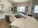 Open kitchen featuring a granite-topped island with stainless steel appliances and modern sink at 12753 W Vista Paseo Dr, Litchfield Park, AZ 85340