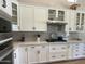 Modern kitchen featuring updated cabinets, countertops, backsplash, and stainless steel appliances at 12753 W Vista Paseo Dr, Litchfield Park, AZ 85340