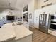 Bright kitchen showcasing countertops, stainless steel appliances, with an adjoining living space at 12753 W Vista Paseo Dr, Litchfield Park, AZ 85340