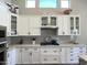 Well-lit kitchen with white cabinets, stainless appliances, light countertops, and modern backsplash at 12753 W Vista Paseo Dr, Litchfield Park, AZ 85340