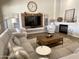 Comfortable living room featuring a large sectional couch, fireplace, and media center at 12753 W Vista Paseo Dr, Litchfield Park, AZ 85340