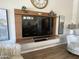 Close up of media center with a modern floating cabinet and designer seating at 12753 W Vista Paseo Dr, Litchfield Park, AZ 85340