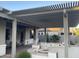 Covered patio with pergola, brick flooring, built in firepit, and seating at 12753 W Vista Paseo Dr, Litchfield Park, AZ 85340