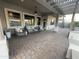 Inviting covered patio with wicker furniture and brick flooring at 12753 W Vista Paseo Dr, Litchfield Park, AZ 85340