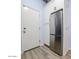Pantry with wood floors, a stainless steel refrigerator, and white cabinets provides ample storage at 12753 W Vista Paseo Dr, Litchfield Park, AZ 85340