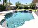 Inviting pool with waterfall feature, complemented by lush landscaping and outdoor amenities at 12753 W Vista Paseo Dr, Litchfield Park, AZ 85340