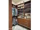 Spacious wood-shelved walk-in closet with hanging racks and built-in drawers at 12753 W Vista Paseo Dr, Litchfield Park, AZ 85340