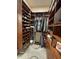 Organized walk-in closet with wood shelving, hanging racks and a shoe rack at 12753 W Vista Paseo Dr, Litchfield Park, AZ 85340