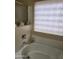 Bright bathroom features a bathtub with chrome fixtures and a window for natural light at 1333 E Cecil Ct, Casa Grande, AZ 85122