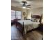 Comfortable bedroom features classic wood furniture, and wood-look floors at 1333 E Cecil Ct, Casa Grande, AZ 85122