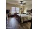 Comfortable bedroom features a ceiling fan, wood-look tile floor, and natural light from a window at 1333 E Cecil Ct, Casa Grande, AZ 85122