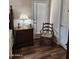 Bedroom with wood-look floors, dresser, and door with natural light at 1333 E Cecil Ct, Casa Grande, AZ 85122