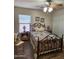 Comfortable bedroom features a closet, ceiling fan, and an ornate iron bed frame with colorful quilt at 1333 E Cecil Ct, Casa Grande, AZ 85122