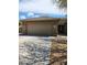Home featuring a two-car garage, low maintenance landscaping, and tasteful stonework accents on the facade at 1333 E Cecil Ct, Casa Grande, AZ 85122