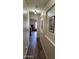 Hallway featuring neutral walls and access to bedroom with wood-look floors at 1333 E Cecil Ct, Casa Grande, AZ 85122