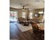 Bright living room boasts wood-look floors, ceiling fan, and access to patio at 1333 E Cecil Ct, Casa Grande, AZ 85122