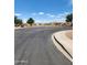 A quiet street corner in a residential neighborhood with a landscaped median and clear blue sky at 1333 E Cecil Ct, Casa Grande, AZ 85122