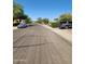 A wide street view in a well-maintained residential neighborhood with mature trees and manicured landscaping at 1333 E Cecil Ct, Casa Grande, AZ 85122