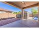 Covered patio with red brick pavers, a concrete extension and gated access to the backyard at 13523 W Remuda Dr, Peoria, AZ 85383