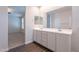 Bathroom featuring double sinks with wood-look tile floor, large mirror and neutral paint at 13523 W Remuda Dr, Peoria, AZ 85383