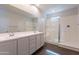 Bathroom featuring double sinks, a glass-enclosed shower, and modern fixtures at 13523 W Remuda Dr, Peoria, AZ 85383