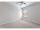 Carpeted bedroom featuring a ceiling fan and bright natural light from a window at 13523 W Remuda Dr, Peoria, AZ 85383