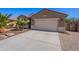 Inviting home with low-maintenance landscaping, paved driveway, and a two-car garage at 13523 W Remuda Dr, Peoria, AZ 85383