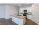 Bright kitchen featuring a center island with granite countertops and wood-look tile floors at 13523 W Remuda Dr, Peoria, AZ 85383