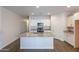 Open kitchen with granite countertops, stainless steel appliances, and a center island at 13523 W Remuda Dr, Peoria, AZ 85383