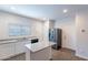 Bright kitchen features white cabinets, granite countertops, and stainless steel refrigerator at 13523 W Remuda Dr, Peoria, AZ 85383
