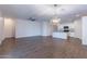 Open-concept living area featuring wood-look tile flooring and easy access to the kitchen at 13523 W Remuda Dr, Peoria, AZ 85383