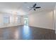 Bright open living room with stylish light fixture, tiled floors, and access to the backyard at 13523 W Remuda Dr, Peoria, AZ 85383