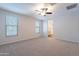 Spacious main bedroom with neutral carpet, ceiling fan, and an ensuite bathroom at 13523 W Remuda Dr, Peoria, AZ 85383
