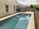 Backyard swimming pool with travertine pavers and outdoor storage shed at 13523 W Remuda Dr, Peoria, AZ 85383