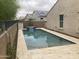 Refreshing pool with water feature and travertine pavers in a landscaped backyard at 13523 W Remuda Dr, Peoria, AZ 85383