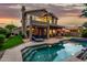 Home exterior with pool, spa, and covered patio, completed by outdoor furniture and beautifully landscaped yard at 13566 N 93Rd Pl, Scottsdale, AZ 85260