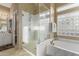 Bright bathroom boasts a marble walk-in shower, soaking tub, and white cabinets at 13566 N 93Rd Pl, Scottsdale, AZ 85260
