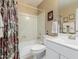 Cozy bathroom features a tub with shower, white vanity, neutral paint and colorful floral shower curtain at 13566 N 93Rd Pl, Scottsdale, AZ 85260